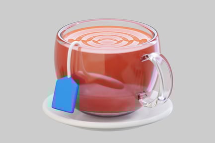 Preview: Warm Tea In Glass Cup With Blue Tag On Saucer