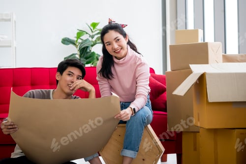 Preview: Happy young couple moving to new house together.