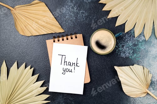 Preview: Notes thank you and coffee cup, dried palm leaves decor on desk on blue background