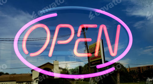 Preview: Lighted orange and pink neon sign in retail small business.