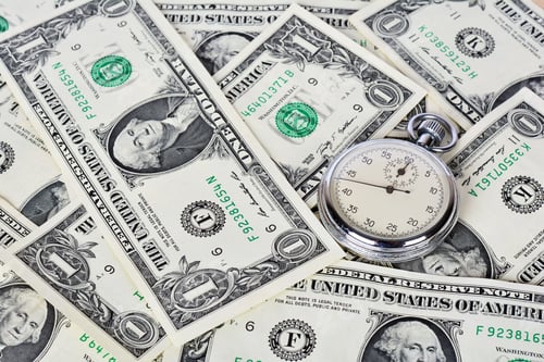 Preview: Clock on paper banknotes - time is money concept