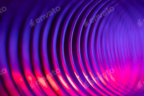 Preview: Closeup of coiled metal spring with sufficiently high strength and elastic properties in neon light