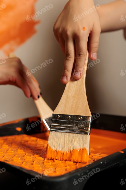 Preview: Small family using paintbrush and color