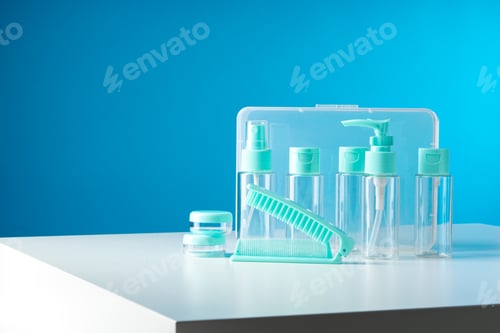 Preview: Clear containers for beauty products arranged on a white surface against a bright blue background