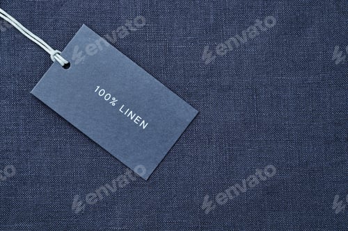 Preview: Label with composition of fabric on cloth background. 100 percent linen