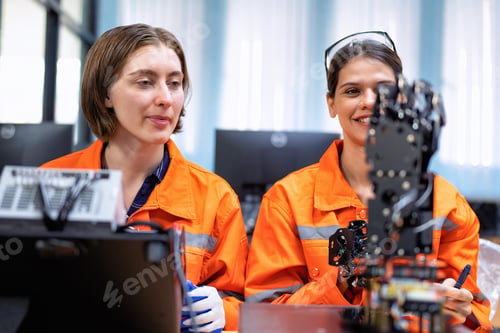 Preview: Girl engineer in robot industry fabrication research room simulate testing robot arm on operation