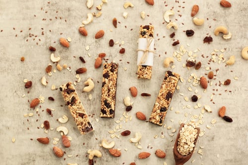 Preview: Homemade Healthy Cereal Bars with Granola, Nuts, and Dried Fruits on Bron Retro Background