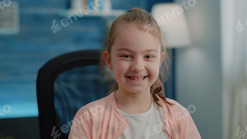 Preview: Close up of little girl sitting at desk and preparing to do homework