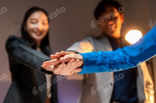 Preview: Three people are shaking hands in a business setting