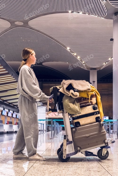 Preview: Young woman traveling solo.Traveller alone at the airport with suitcases,big luggage,travel banner