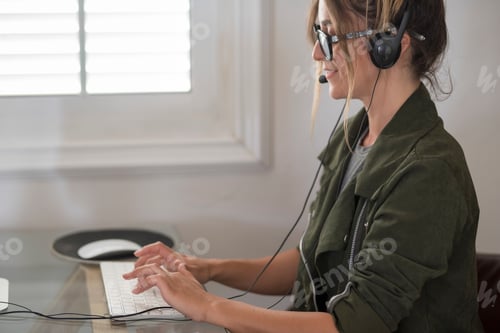 Preview: Adult woman type on laptop computer and smile happy for smart working free office home