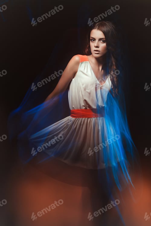 Preview: Blurred color art portrait of a girl on a dark background. Fashion woman with beautiful makeup and a