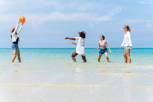 Preview: group of girls of different ethnicities running and having fun together at beach