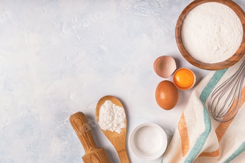 Preview: Ingredients for baking - flour, wooden spoon, eggs.