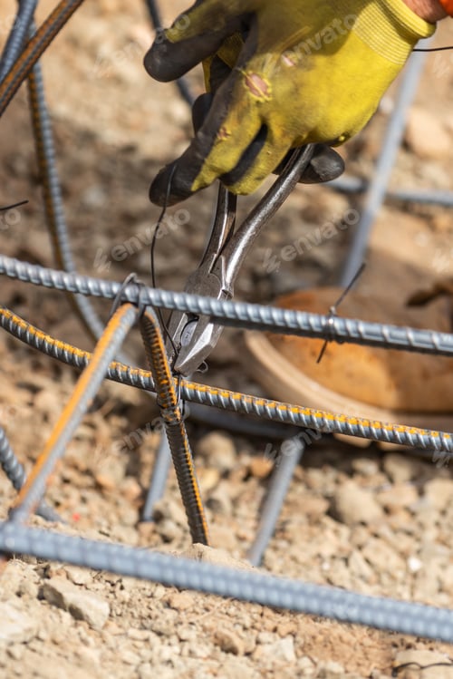 Preview: Worker Securing Steel Rebar Framing With Wire Plier Cutter Tool At Construction Site