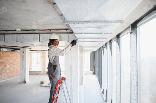 Preview: Construction worker installing ventilation system in building