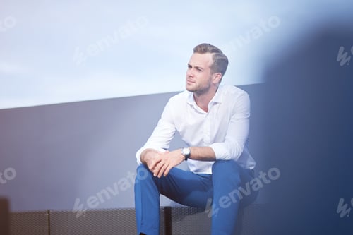 Preview: Thoughtful Man Sitting on a Bench Outside