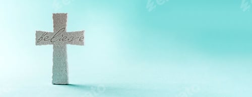 Preview: Stone cross with inscription Believe on grey background, Copy space. Christian backdrop. Biblical
