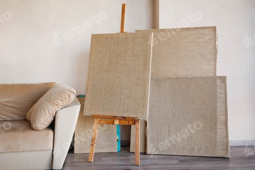 Preview: Clean canvases for artist in the bright interior of room by sofa