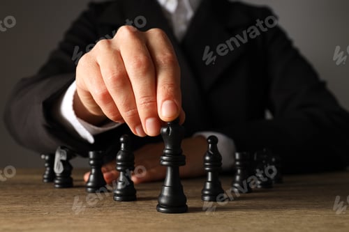 Preview: A man in a black suit with chess on the table