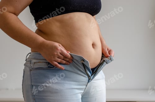 Preview: fat woman trying to zip up her jeans pants