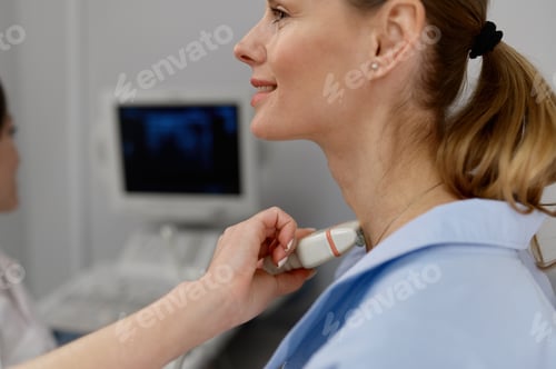 Preview: Woman doctor conducting ultrasound of thyroid gland and lymph nodes