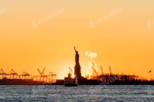 Preview: Statue of Liberty silhouetted with sunburst at sunset