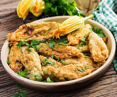 Preview: Fried zucchini flowers stuffed with ricotta and green herbs. Vegan food. Italian cuisine.