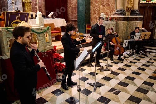 Preview: Musicians perform classical music during a concert in a historic church setting