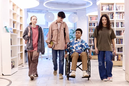 Preview: Inclusive Group of Teenagers Walking Towards Camera in Library