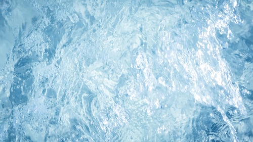 Preview: Blurred motion of moving water headed to the beach.