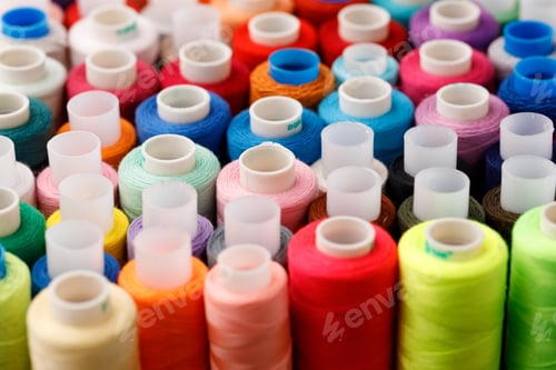 Preview: Close up of colored thread coils, thread spools background