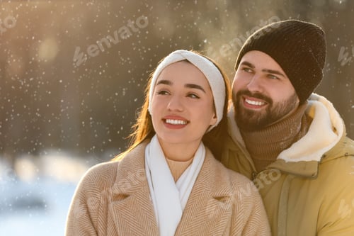 Preview: Beautiful young couple enjoying winter day outdoors