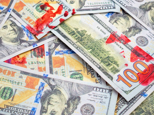 Preview: Closeup shot of dollar bills with red blood spots on them
