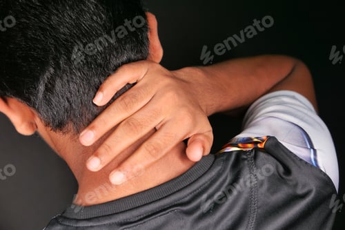 Preview: man suffering from neck or shoulder pain at home.