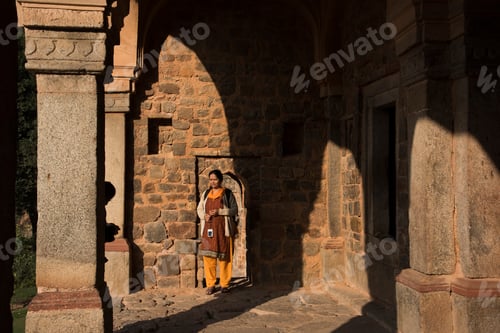 Preview: Portrait of Indian woman in front old stone wall.