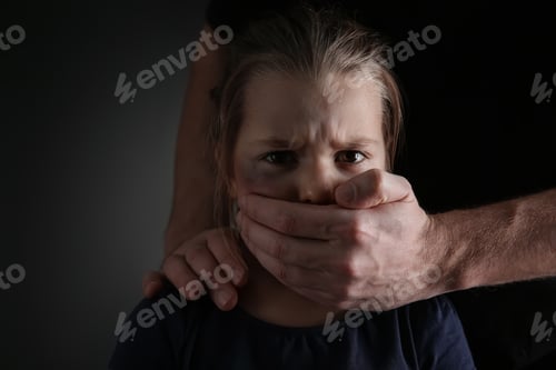 Preview: Man covering scared little girl's mouth on black background. Domestic violence