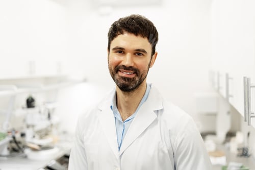 Preview: Portrait of smiling scientist standing in his laboratory