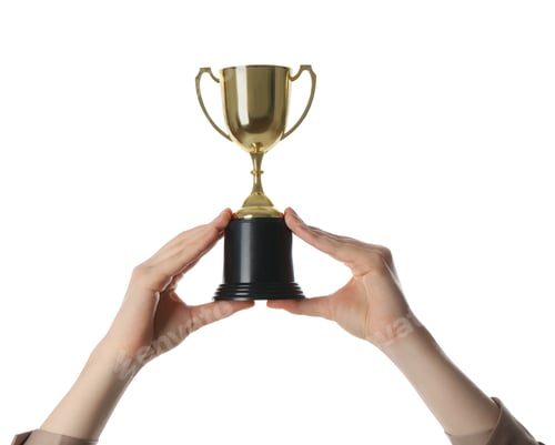 Preview: Woman with golden trophy cup on white background, closeup
