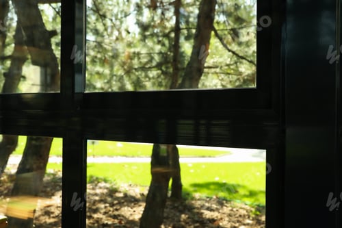 Preview: Black window frame in restaurant against park