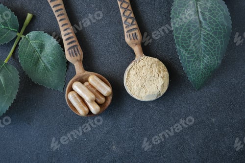 Preview: top view of herbal medicine capsule and powder on wooden spoon