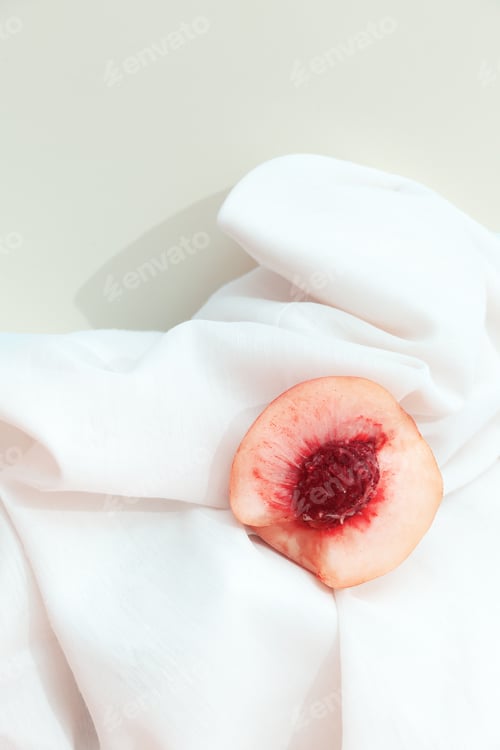 Preview: Still life scene with fresh peach and white textile background. Minimal aesthetic.