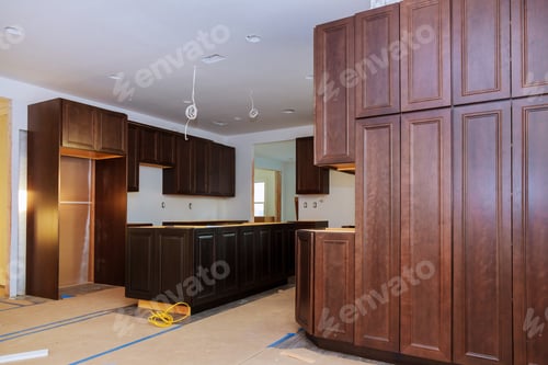 Preview: Custom kitchen cabinets in various stages of installation base for island in center
