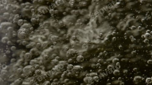 Preview: Closeup champagne bubbles moving inside wineglass in super slow motion.