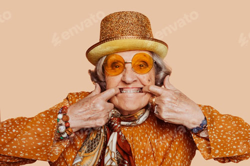 Preview: Elderly stylish grandmother doing funny face at studio