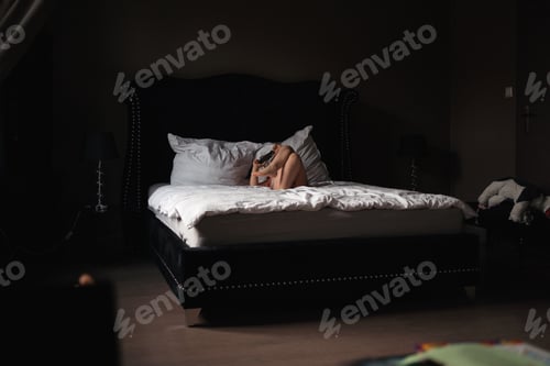 Preview: 5 years old girl watching cartoons on mobile phone on the bed. royal luxury interior