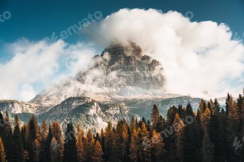Preview: Tre Cime mountain peak with cloudy and autumn forest in Dolomites, Italy