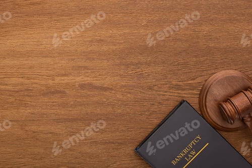 Preview: top view of bankruptcy law book and gavel on wooden background