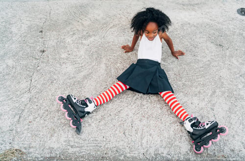 Preview: Tired female with roller skates lying on road