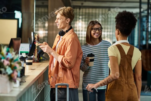 Preview: Colleagues enjoying a business trip at a modern hotel reception